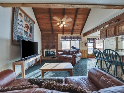 View of the spacious living room featuring comfortable seating, a warm and inviting atmosphere, and plenty of space to relax after a day of adventure.