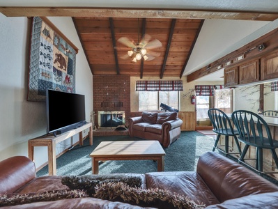 View of the spacious living room featuring comfortable seating, a warm and inviting atmosphere, and plenty of space to relax after a day of adventure.