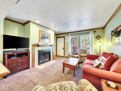 View of Living Room, gas fireplace, 40" HDTV, queen sofa pull out bed, coffee table and arm chairs