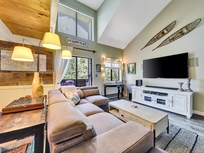 View of Living Room Sofa, smart TV, blue ray video vaulted ceiling, fireplace, floor lamps, entertainment console, coffee table