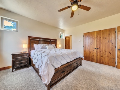 Primary Bedroom Primary Bedroom King Size Bed, Ceiling Fan, Nightstands, Lamp, Walk-in Closet