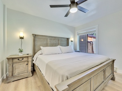 Primary Bedroom, King size Bed with Side Tables that Include USB Drive Connections, Sconces & Ceiling Fan