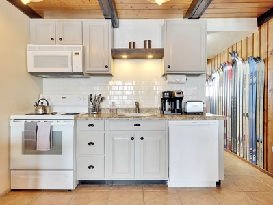 View of Kitchen with Electric Stove, Microwave, Dishwasher, Coffee Maker, Toaster, Teapot, Refrigerator, Slow Cooker