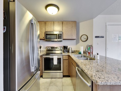 View of fully stocked kitchen with new stainless steel appliances