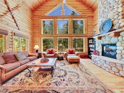 View of Living Room with Floor to Ceiling Gas Fireplace and Forest Views