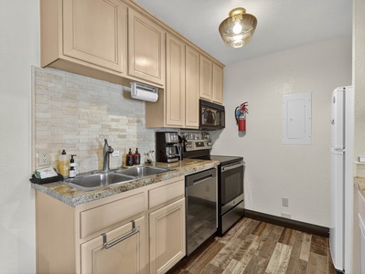 Fully equipped galley kitchen with brand-new appliances and plenty of storage, perfect for cooking during your mountain stay