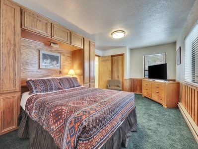 Primary bedroom featuring a queen-size bed with comfortable bedding and a 42" Smart TV for your entertainment