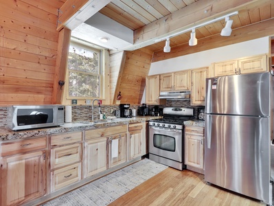 View of the kitchen featuring stainless steel appliances and fully stocked with everything you need to prepare meals and enjoy your time at the cabin