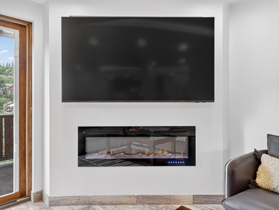 View of the living room TV and gas fireplace