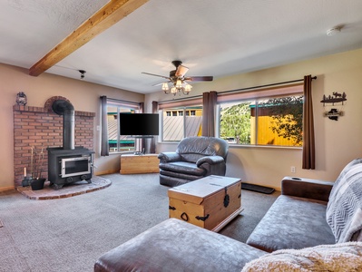 Living Room Living Room Wood stove, 55" Smart TV, queen sleeper sofa, pine wood chest, arm chair, fan