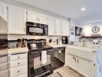 View of Upgraded Kitchen with Electric Stove, Oven, Toaster, Coffee Maker, Dishwasher, Microwave, Range, Refrigerator, Upgraded Cabinetry, and Farmhouse Sink