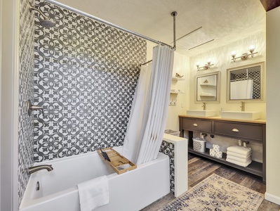 View of Primary  Bathroom,  Combination shower/tub, double sinks and mirrors, modern tile detail