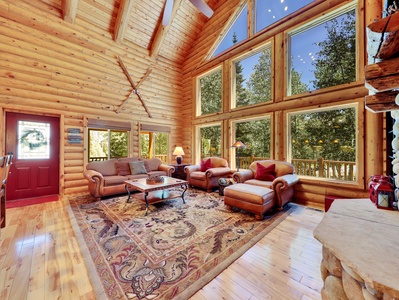 Living Room with Floor to Ceiling Gas Fireplace and Forest Views