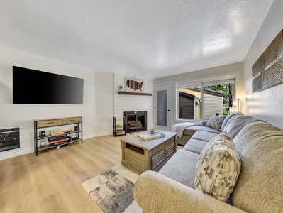 View to the living room, 65" Smart TV, Convertible Coffee Table, Wood Burning Fire Place