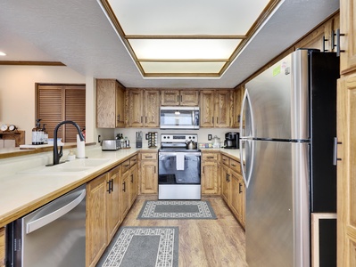 Fully equipped kitchen with upgraded appliances, including a dishwasher, refrigerator, stove, and oven, along with modern cabinetry and all the essentials to make your stay comfortable