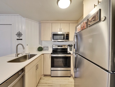 View of the newly upgraded kitchen featuring brand-new appliances, a Keurig coffee machine, toaster, dishwasher, and all the cooking essentials to make your stay comfortable and memorable.