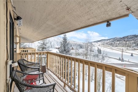 Private balcony offering stunning views of the surrounding trees and charming mountain town