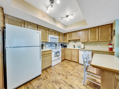 View of Kitchen, refrigerator, stove/oven, microwave, toaster, coffee maker, ample counter space and dining area