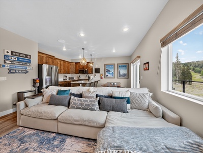 View of the comfortable living room sectional to the dining and kitchen areas
