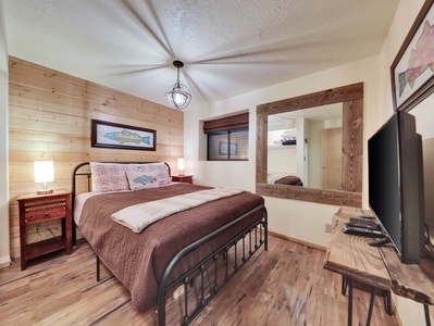 View of bedroom 4 located on the first floor with queen size bed and smart TV