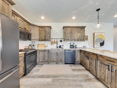 View of Fully Loaded Kitchen: The kitchen is fully equipped with high-end appliances and a spacious layout