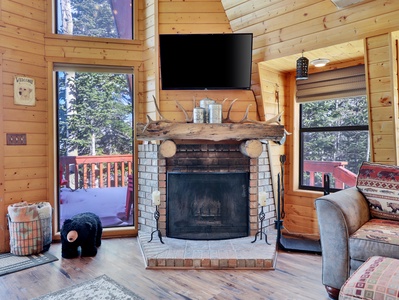 Wood burning fire place located in the main living room and 43" smart TV