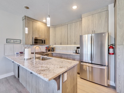 View of Kitchen with Modern Cabinetry, Upgraded Lighting and Appliances