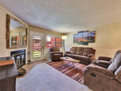 Living Room Living Room Wood burning fireplace, custom mirror, sofa, arm chair, floor lamp and coffee table