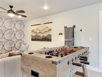 View of Game Room with Ceiling Fan, Extra Blankets and Foosball Table