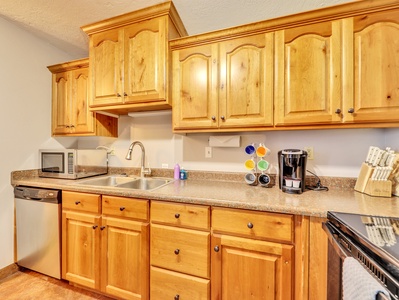 Kitchen Cabinetry, Stainless Steel Sink & Faucet, Microwave, Dishwasher, Keurig Coffee Maker, Knife Block