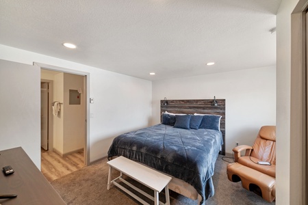 Primary bedroom with queen size bed and smart TV