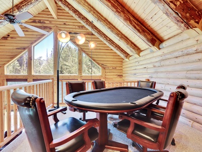 View from the loft located on the 3rd floor.  Poker table with ample seating and lighting as well as views to the forest