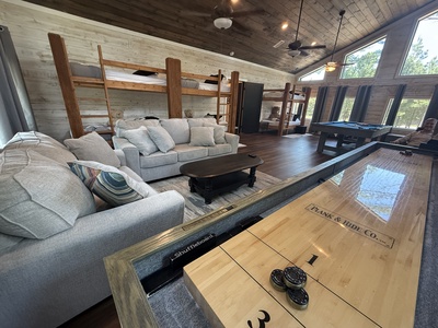 Gameroom with 3 sets of bunk beds (sleeps 6), pool table, shuffleboard board games, and 2 TVs.