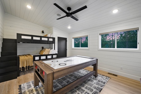 The loft is sure to be popular with kids of all ages! The room comes equipped with a built in twin over full bunk set, as well as multi-game table, and smart TV. There is an full bath up here for the loft guests!