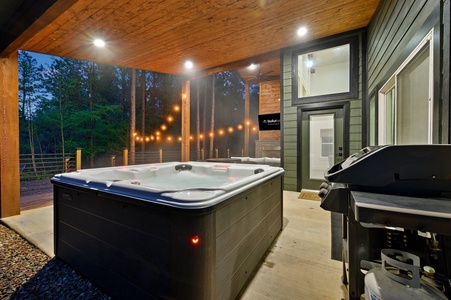 Enjoy the hot tub with cafe lights and trees as your view!