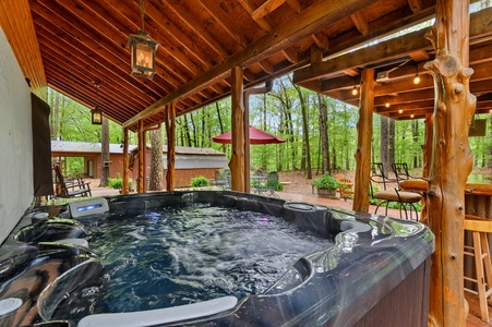 Your hot tub sits next to the outdoor bar and grill.