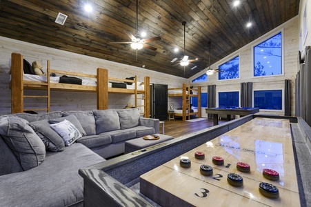 Gameroom with 3 sets of bunk beds (sleeps 6), pool table, shuffleboard board games, and 2 TVs.