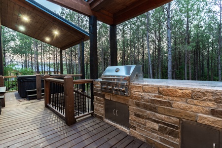 Outdoor deck with a built-in stainless steel grill.