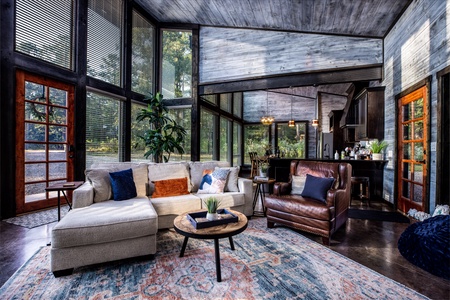 Living room with the kitchen and the dining room in the background.