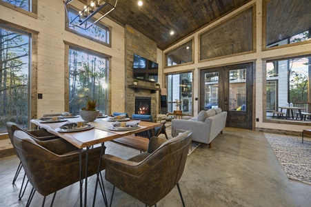 Dining table with seating for 6  near the gas fireplace and living room for a communal ambience