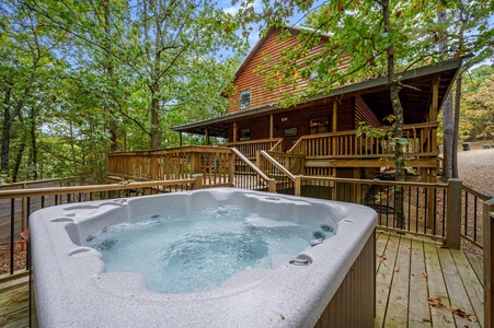 Enjoy the private hot tub on the deck sitting among the trees of the Ouachita National Forest.