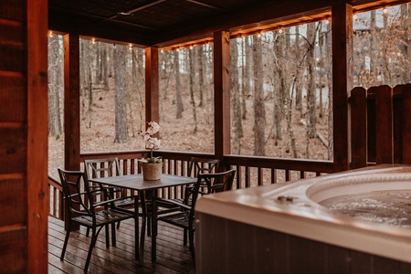 Your private hot tub awaits, easily accessible off the main wraparound porch.