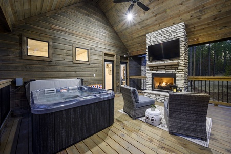 Unwind in the hot tub or lounge by the outdoor fireplace on the spacious, covered deck—perfect for year-round relaxation.