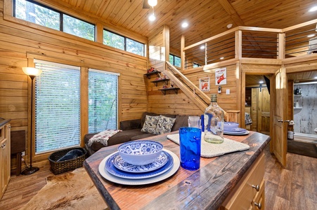 This tiny home has a comfy and rustic interior. Please note: the couch has since been replaced with a new leather love seat and no longer has a lounging seat.