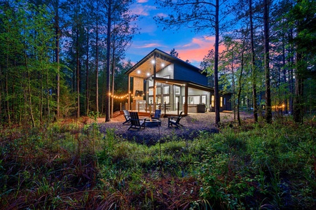 Gorgeous modern architecture of your cabin with cafe lights and a firepit amongst the trees