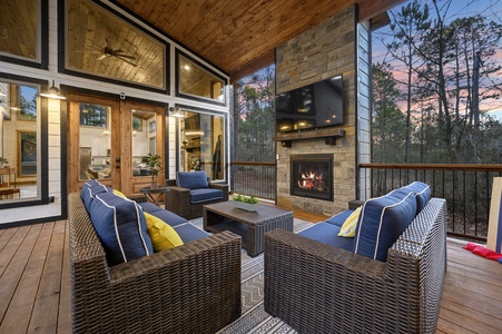 A deck that dreams are made of! Propane grill, hot tub, 70'' TV and seating for all around the gas fireplace for ambiance