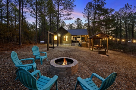 Enjoy serene evenings around the fire pit with family or friends at the Early Bird. The soft glow of string lights enhances the peaceful forest setting.