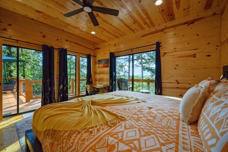 Now this is a vacay vibe! The primary en suite features elevated forest and distant mountain views directly from bed.