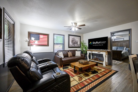 Step into the heart of Bear Assets, a cozy living space featuring leather recliners and a plush couch, perfect for relaxing after a day exploring Broken Bow’s natural beauty.