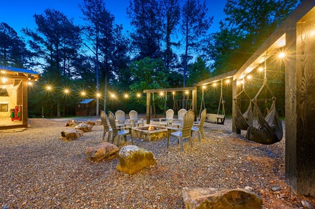 Take a look at this sweet fire pit set up! Swings on swings on swings! Plenty of seating for the whole group to enjoy family stories and a s'more buffet (yeah, that's a real thing).